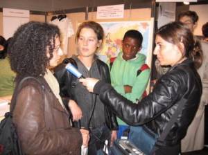 Salon of Peace Initiatives, Paris 2006: two French teachers being interviewed by Europe 1 radio in front of IofC booth. Both come from schools where IofC is doing workshops. 
							